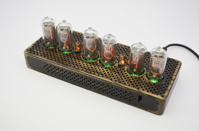 Nixie clock with drilled pattern.